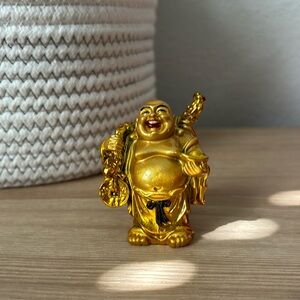 Gold Buddha with black bow